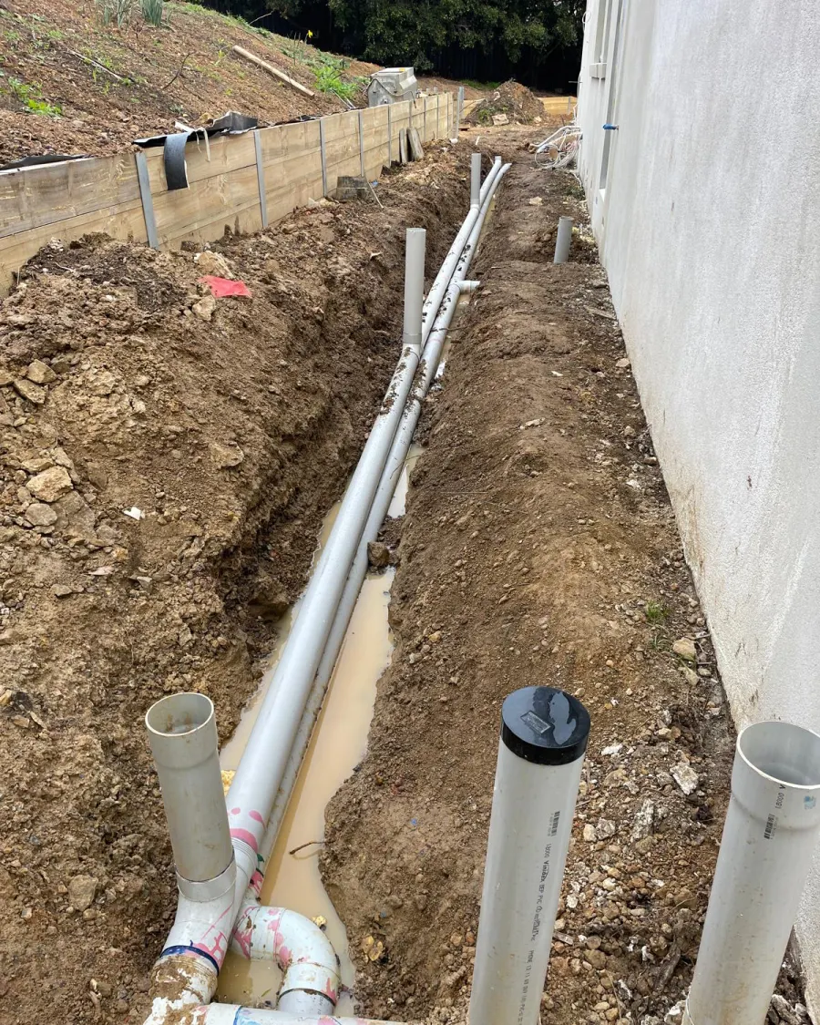 New subsoil drainage laid in an excavated trench against the building